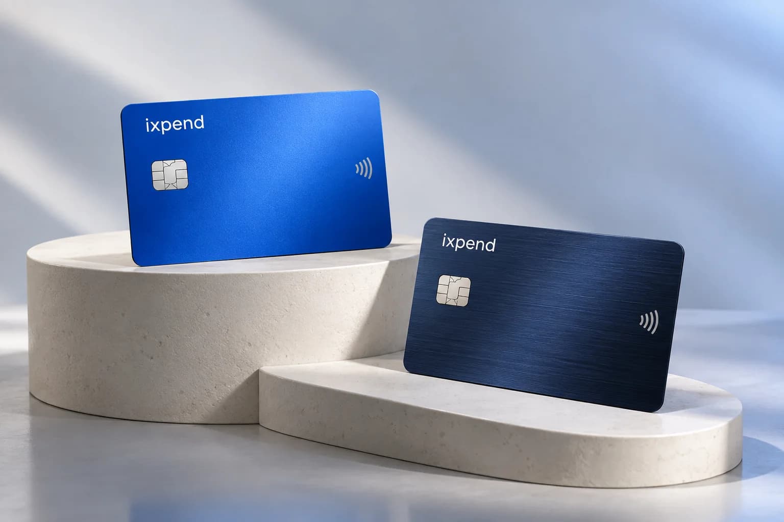 Blue and midnight ixpend cards displayed on studio plinths